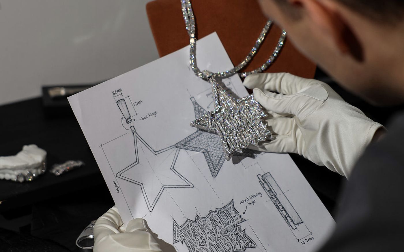 Iced London — a pendant checked against its drawings at the bench